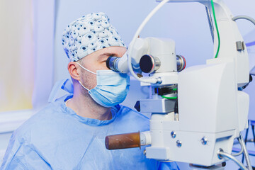 Operation under a surgical microscope for vision correction. Eye surgery. A patient and a surgeon...