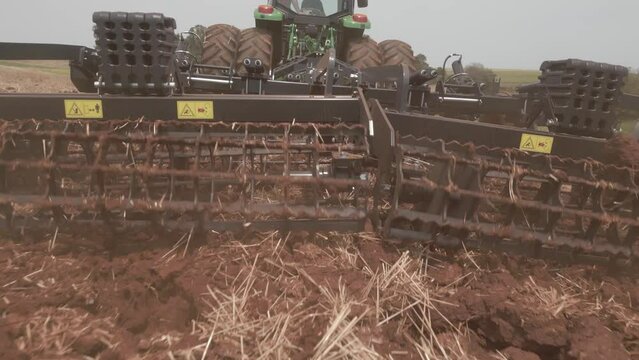 Tractor with soil scarifier preparing for planting on land in the interior of Brazil. Raw Footage.