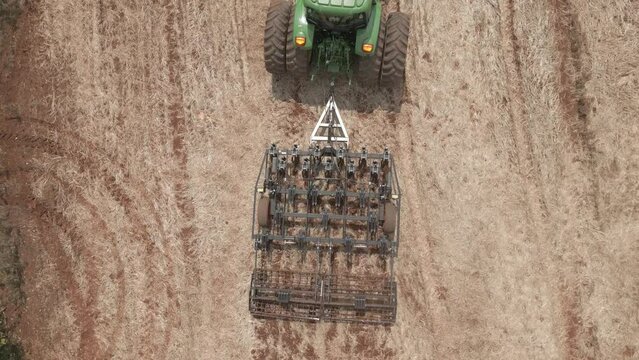 Tractor with soil scarifier preparing for planting on land in the interior of Brazil. Raw Footage.
