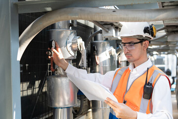 Engineers are inspecting a large building or industrial facility's cooling system for the air...