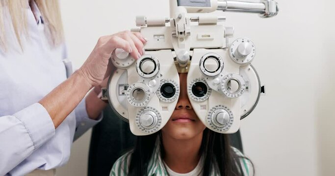 Eye care, vision and child in clinic, test and help of specialist, phoropter or refractor for girl. Healthcare, technology and medical for eyesight of kid, exam and machine for check up in hospital