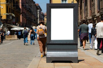 White display or billboard in Milan, many pedestrians.