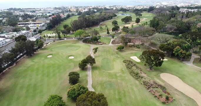 Aerial view golf course professional players practicing the sport, background city.  santo domingo.