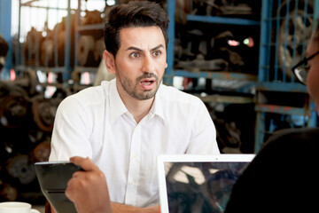 Unhappy man feel shocked and surprised by employee description prices of services and products in...