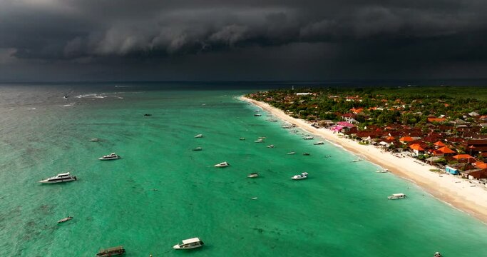 Dark Storm Clouds Over The Sea And Beach In Nusa Lembongan Island In Bali, Indonesia. - aerial shot