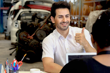 Happy man is pleased, give thumb up with suggestions, products and services. Buyer talks with staff...