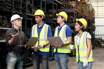 Industrial woman and man worker with safety vest and helmet listen to senior foreman, discuss to work together at manufacturing plant factory. Professional engineer team working in industry workplace.