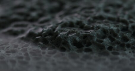 Ultra Close-Up of a Highly Porous Stone Surface with water. Dolly shot, shallow dof.