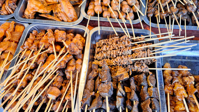 Various types of food and satay menus sold at Angkringan or street food carts in Yogyakarta, Indonesia.
