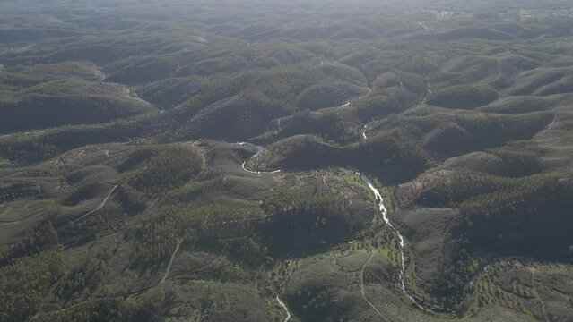 Aerial view of the green landscape of Proen&ccedil;a a Nova, Portugal. Drone slowly moving forward showing the all extension of the green forest and the orography of the mountains and the river. 4K, 60fps.