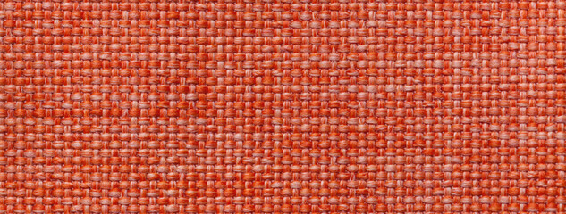 Texture of dark orange background from woven textile material with wicker pattern, macro. Vintage...