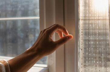 Hand close to window with sunlight