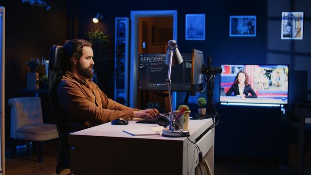 Experienced programmer writing code on computer screen while in office using java programming languages. Developer working on fixing database errors while working from home, camera B