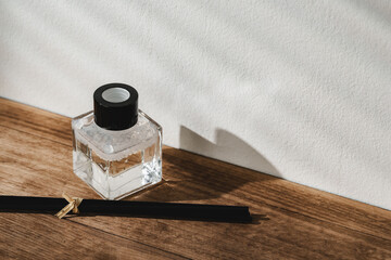 Elegant Perfume Bottle Bathed in Sunlight on a Wooden Surface