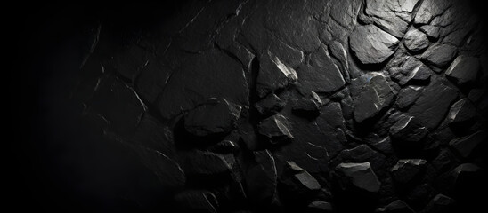A stone wall stands starkly against a black background, showcasing its rugged texture and solidity - obrazy, fototapety, plakaty