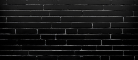 A monochromatic image showing the details of a brick wall, with a variety of shapes, textures, and patterns present