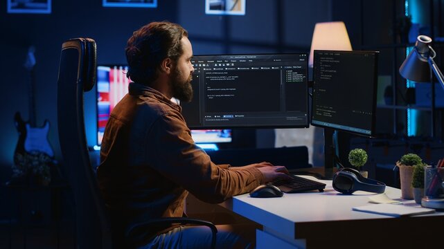 Programmer developing code on computer screen while in personal office using java programming languages. IT admin working with software tool, fixing database errors while working from home, camera A