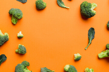 Flat lay composition with fresh green broccoli frame eith copy space on light background