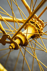 Old bicycle wheel painted in vibrant yellow color