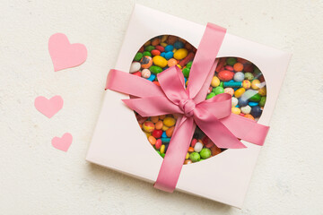 Valentine day composition: sweet candy, with gift boxes with bow and red felt hearts, photo...
