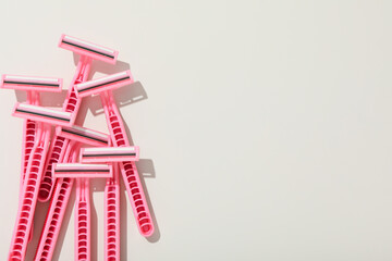 Pink razors for shaving on a white background