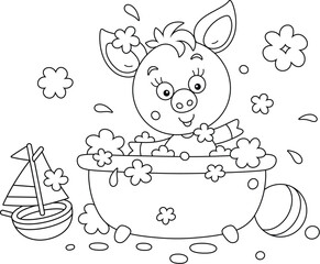 Funny little piglet playing in a bubble bath and splashing with foam in a home bathroom with toys, black and white vector cartoon illustration for a coloring book