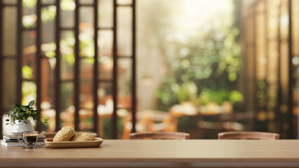 A rustic wooden tabletop, with a blurred background featuring the beautiful garden of a restaurant.