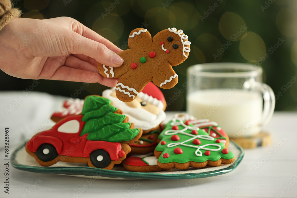 Wall mural Woman with decorated Christmas cookies at table, closeup