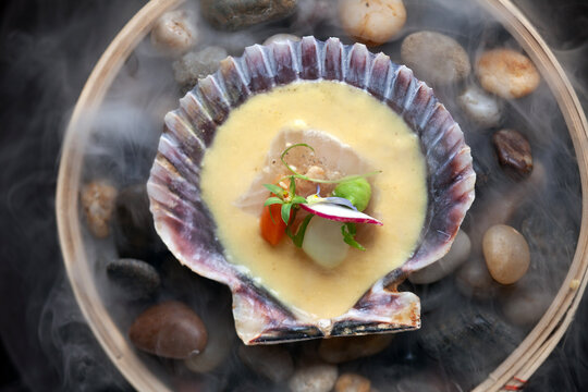 Overhead view of clam shell with upscale seafood bite