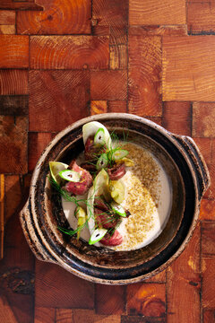 Overhead view of bowl of chowder on wood surface