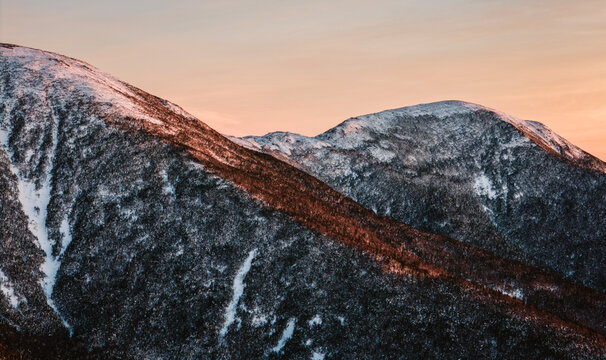 Evening light hits a snow covered mountain ridge, New Hampshire