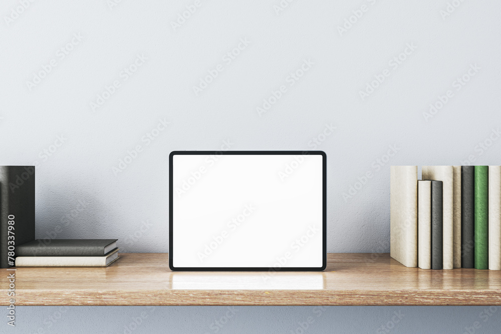 Aufkleber close up of creative wooden designer desk with books and empty white mock up tablet on light concret