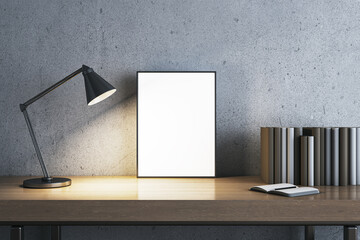 Modern concrete workplace with lamp, books and white mock up banner. Workspace close up. 3D Rendering.