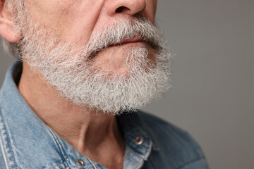 Man with mustache on grey background, closeup
