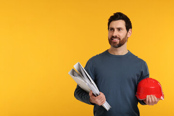 Architect with hard hat and folders on orange background, space for text
