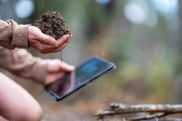 farmer hold soil in hands monitoring soil health on a farm. conducting soil tests