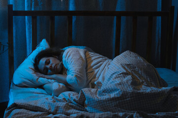 Insomnia. Woman lying awake in bed at night.