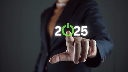 Businessman touching to virtual start button icon with 2025 for start merry Christmas and happy new...