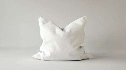 A soft, white pillow sits on a solid white background. The pillow is slightly wrinkled, and the light is reflecting off of it.