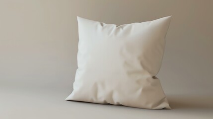 A soft, white pillow sits on a beige background. The pillow is slightly wrinkled, and the edges are frayed.