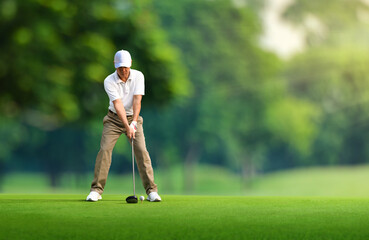 Golf approach shot with driver on teeing ground. © Paitoon