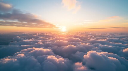 Amazing view above the clouds at sunset. The soft colors of the sky and the clouds create a...