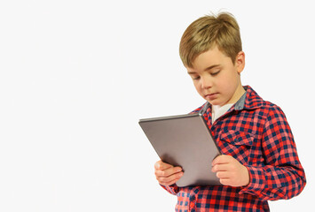 Boy 7-8 years old with a tablet, computer gadget on a white background, copy space