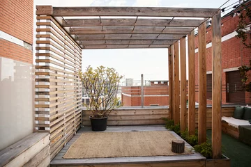 Foto op Aluminium A tranquil outdoor space featuring a charming wooden pergola adorned with climbing vines and a filled planter box © LIGHTFIELD STUDIOS