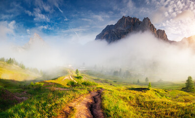 Misty view of the Mt. Tofana di Rozes from Falzarego pass. Dolomites, South Tyrol, Italy, Europe.