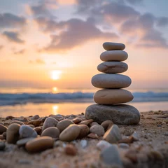 Foto op Plexiglas Balanced pebble pyramid silhouette on the beach with the ocean in the background, Zen stones on the sea beach, meditation, spa, harmony, calmness, balance concept © YOUCEF