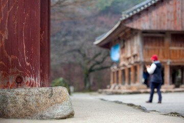 Fototapeta na wymiar View of the Buddhist temple with a walking tourist