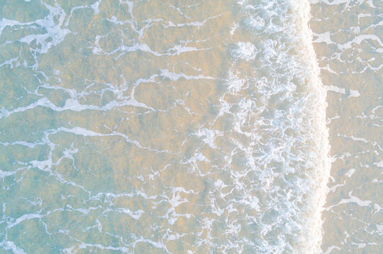 close up view of the sea water reaching the shore of the beach, texture for backgrounds
