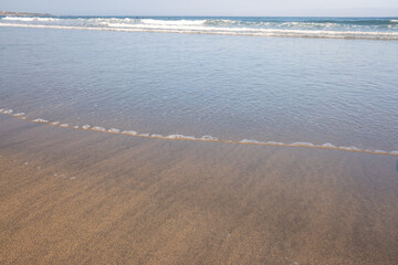 shore of a beach at sunrise at low tide