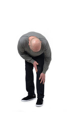 man crouching with leg pain on white background - 780366739
